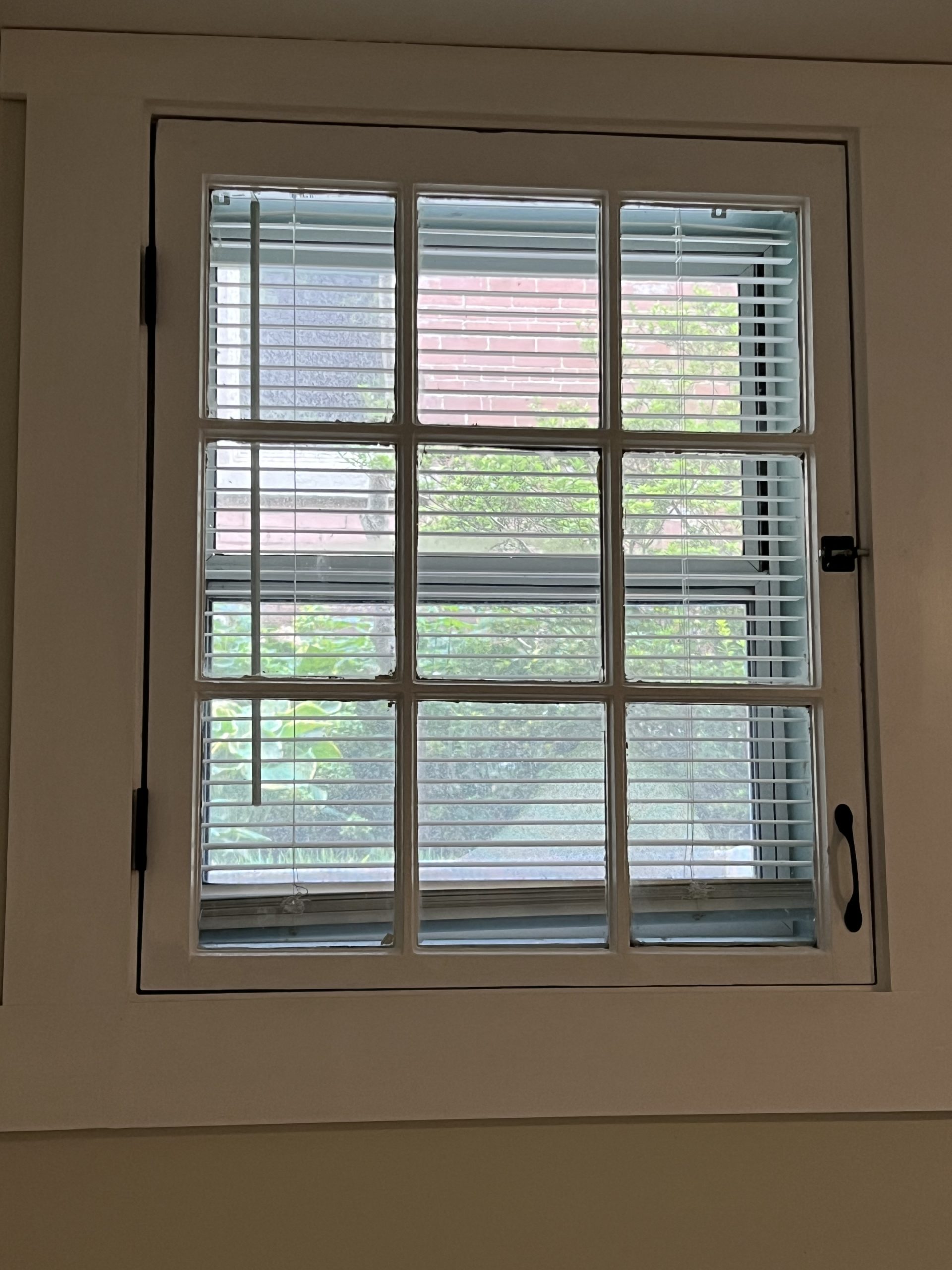 A bedroom window in apartment 6 at 1264 Cherokee Road